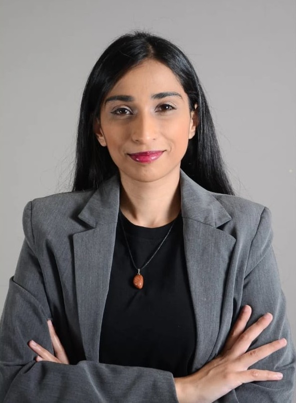 Portrait of Naadirah Kagee smiling in a green blazer
